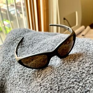 Black sunglasses with bronze reflective lenses. Very good condition.